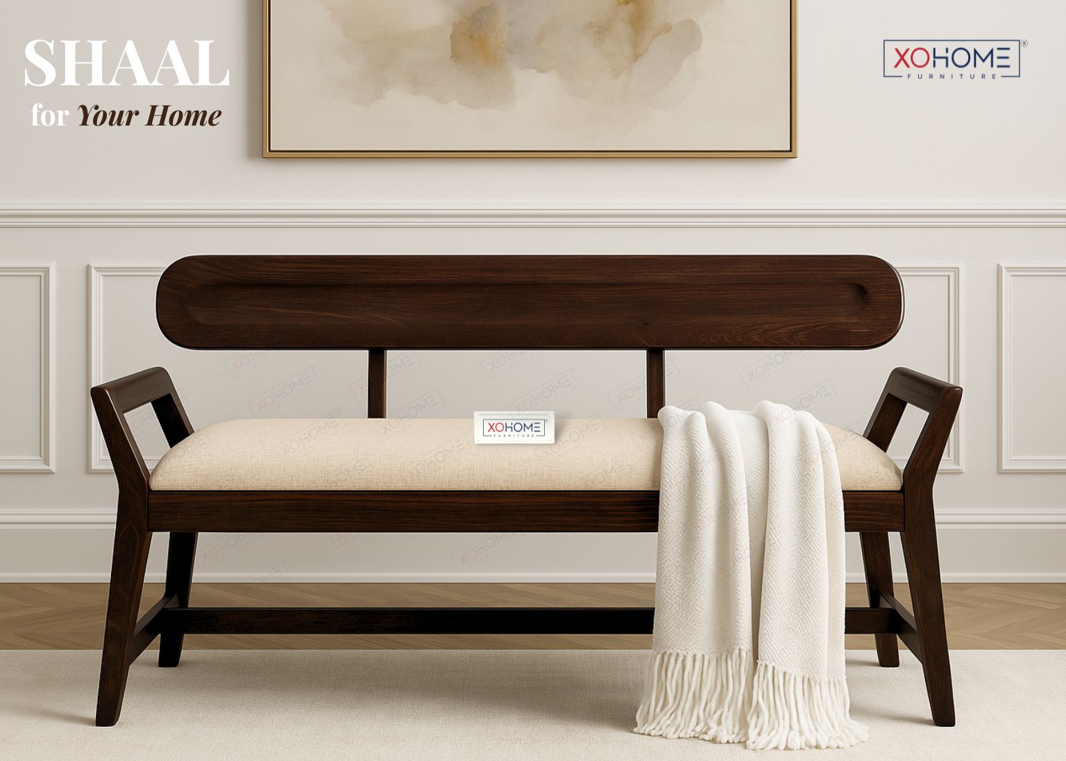 Wooden bench with beige cushion and white blanket in a room with framed artwork on the wall.