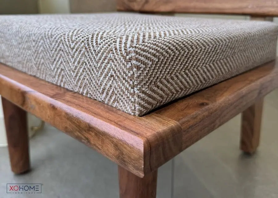 Close-up of BHUMI pure solidwood low seating chair cushion showing premium textured fabric, soft feather-touch upholstery and handcrafted wooden frame with natural grain finish
